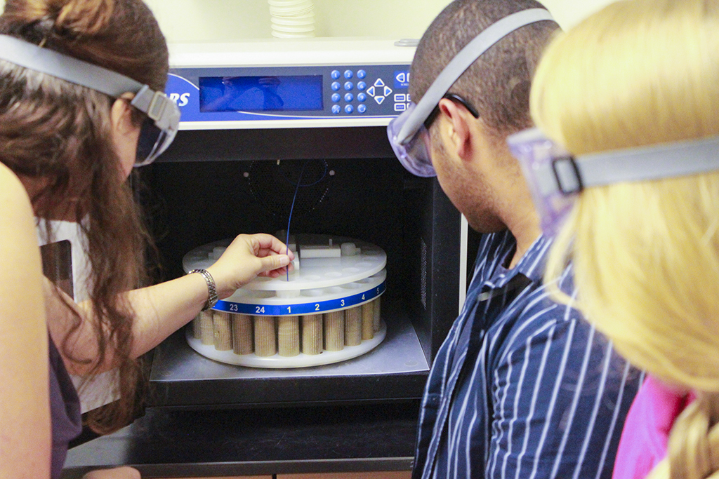 Eller and students Ashton Engdahl and David Darby working with the CEM MARS 5 Microwave Accelerated Reaction System.