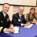 Photo by Darren Farrell: Rear Admiral Randy Mahr, Commander, Naval Air Warfare Center Aircraft Division; Joseph Urgo, St. Mary’s College president; and Bonnie Green, executive director, The Patuxent Partnership, at signing ceremony on October 18.