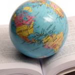 Globe sitting on open book.