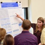 a student researcher presents her project for faculty and others at SURF symposium