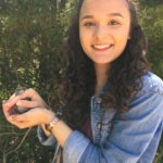 SMCM student Elizabeth Johnson holds a white-throated sparrow