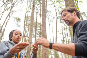 Biology student measuring trees
