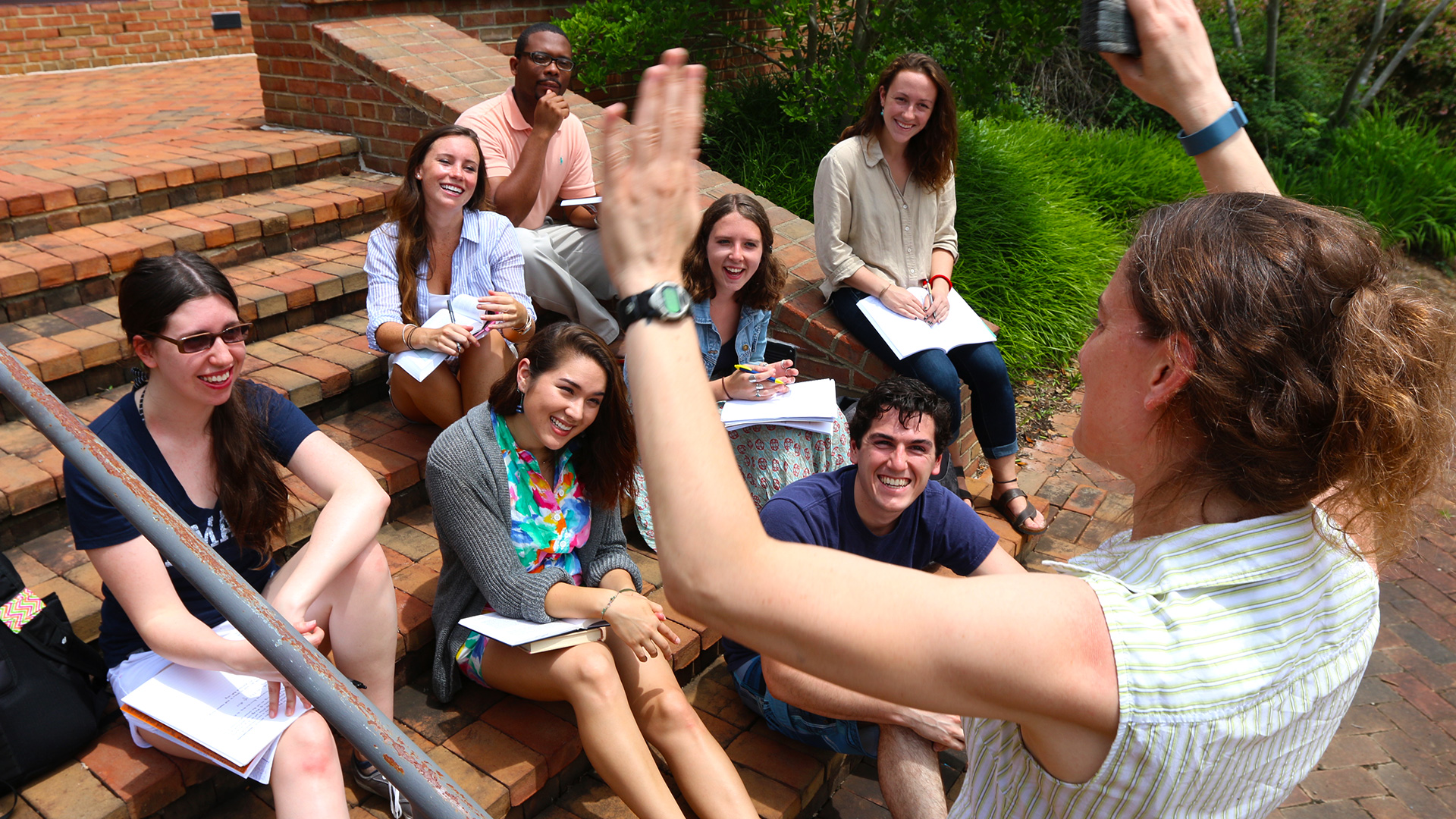 SMCM students enjoy an outdoor class on the brick steps near the science department.