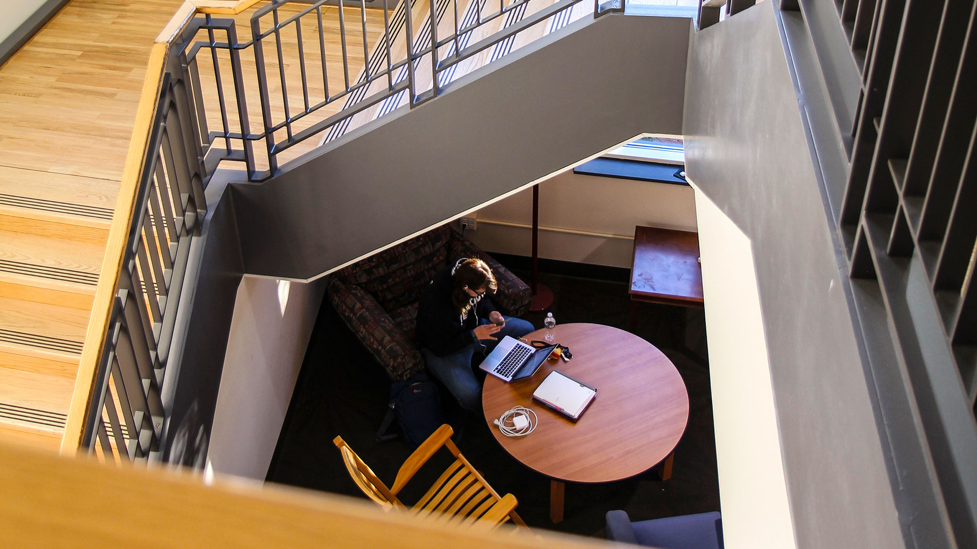 An SMCM student can be seen in the study nook under the 3rd floor stairs in the Hilda C. Landers Library
