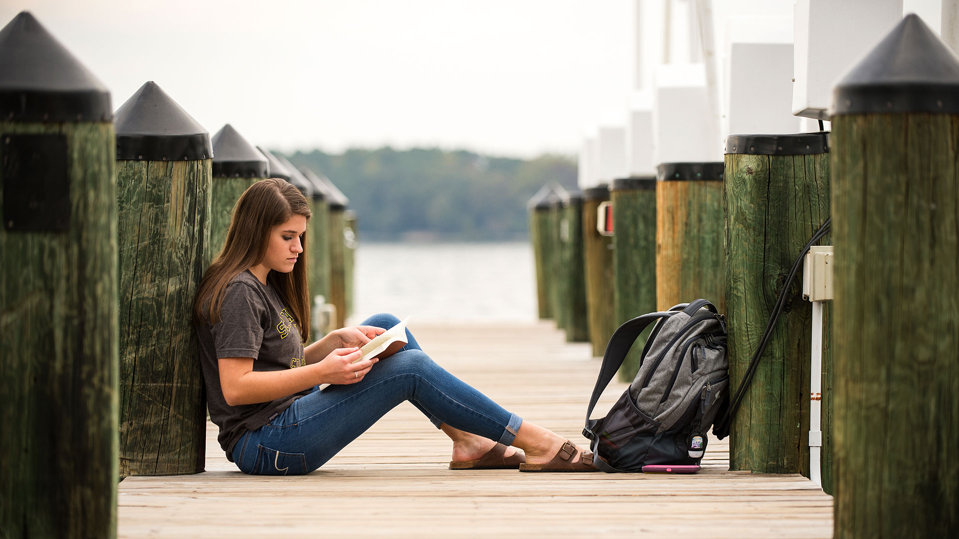 SMCM student studies on the riverfront dock.