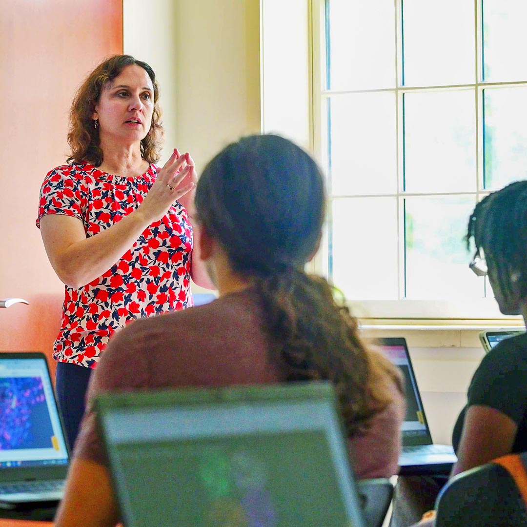 Pamela Mertz teaching in a classroom that includes a large window with lots of natural light