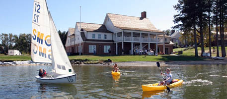Boathouse featuring sailboat and kayakers