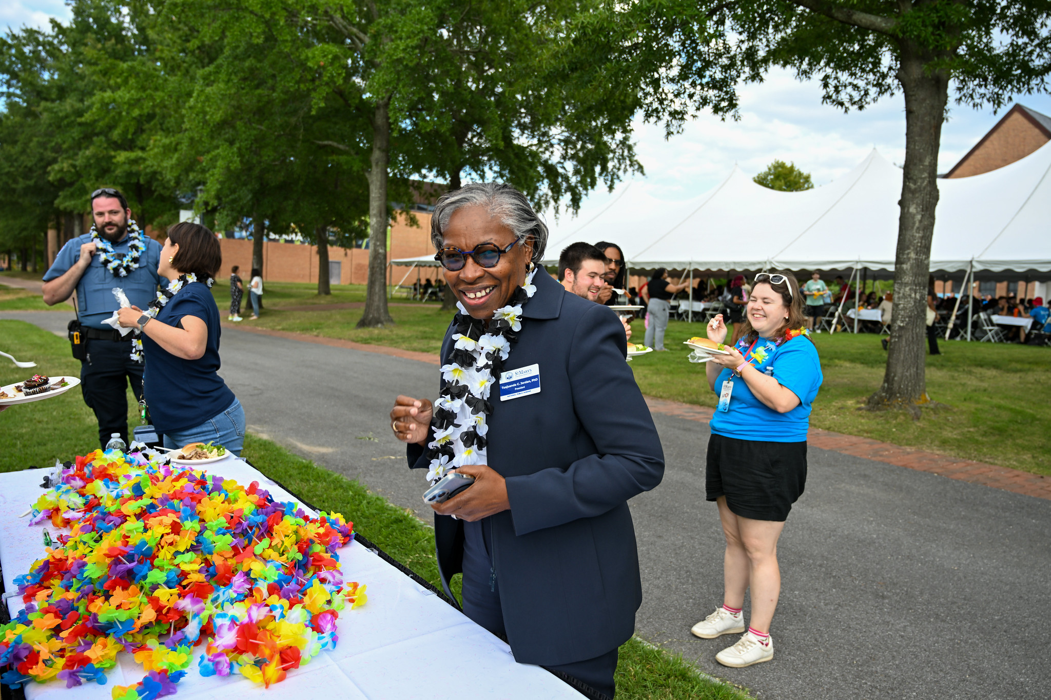 President Jordan  wearing a lei at the new student BBQ