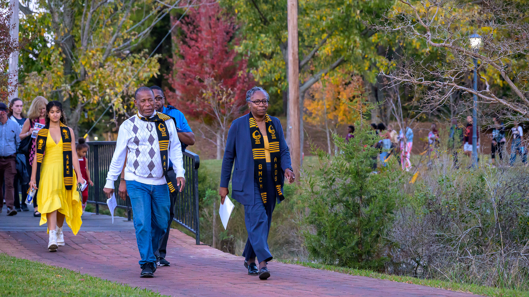 President Jordan leads tSacred Journey participants on the College's walking path