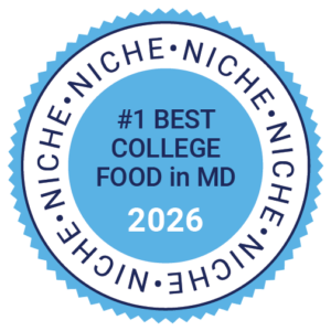 Blue and white badge reading "#1 Best College Food in MD 2026," highlighting exceptional dining options.