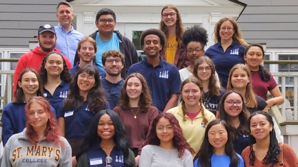 The SAGE student group meets outside the Bonnie M. Green Alumni Center for a group photo