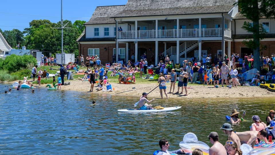 SMCM alumni enjoy the waterfront, looking back at the River Center beach from the docks