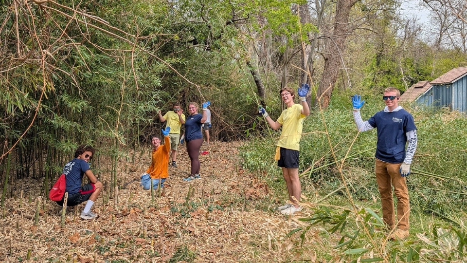 Bay to Bay Service Day Woodland Cleanup, waving for the camera