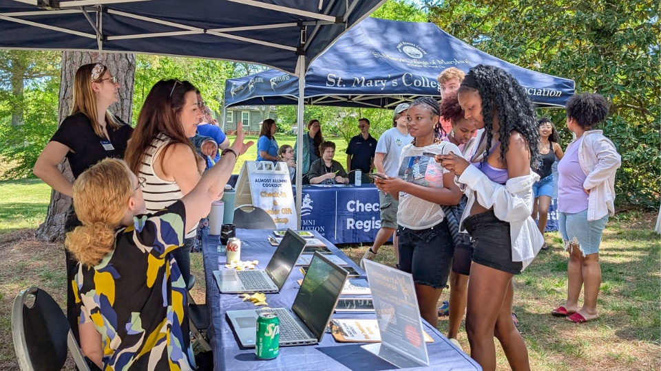 SMCM Almost Alumni Cookout 2025 - students check in with the career center tent