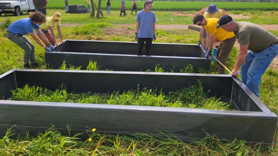 SMCM Bay to Bay Volunteers build out raised garden beds at a past project