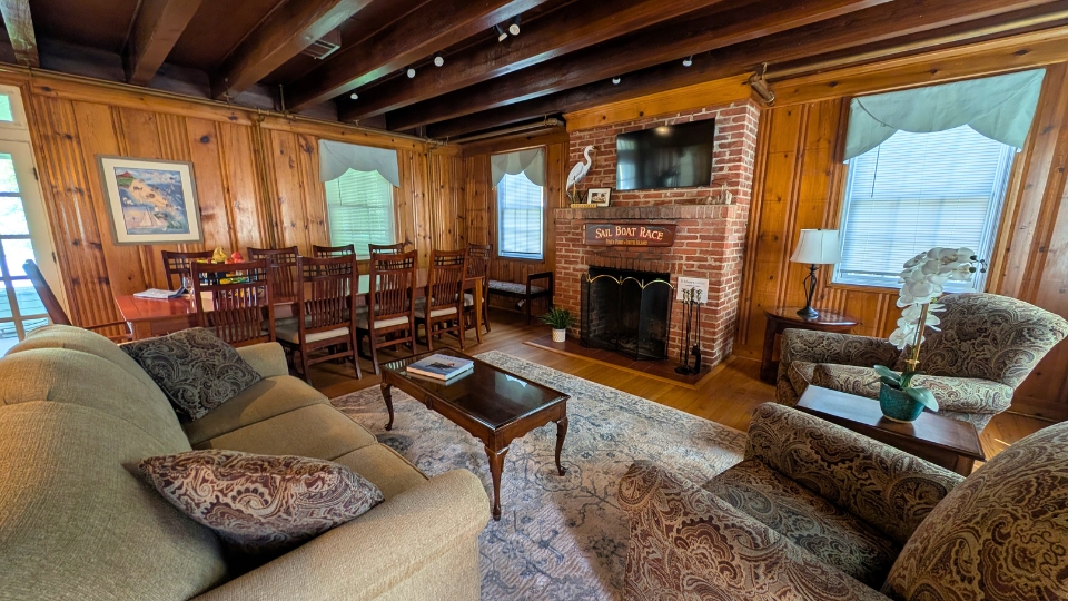 The May Russell Alumni Lodge main room on the first floor facing the fireplace.