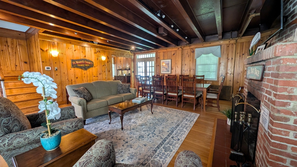 The May Russell Alumni Lodge main room on the first floor facing the back porch entrance.