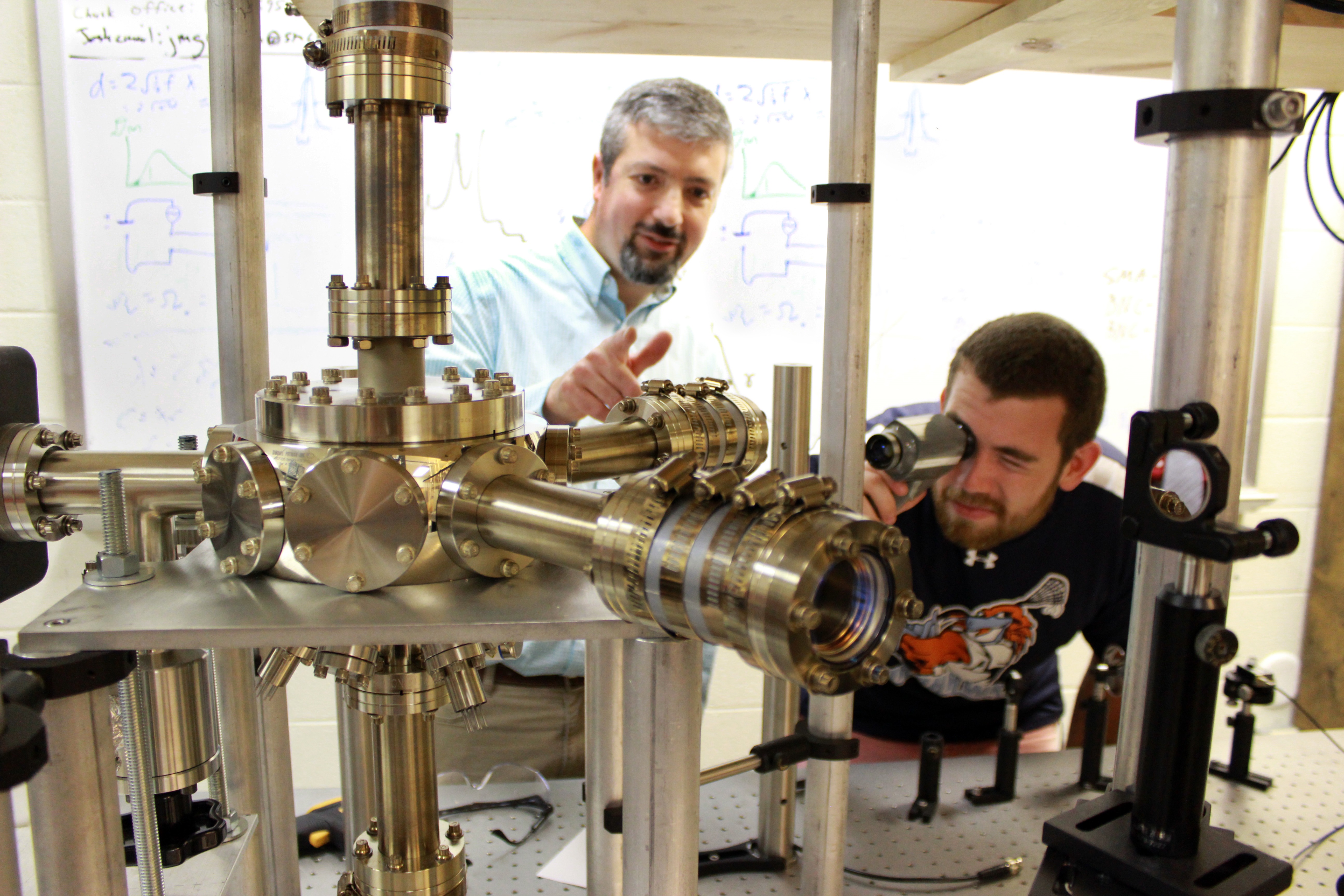 a student performing an atom-trapping experiment in physics class