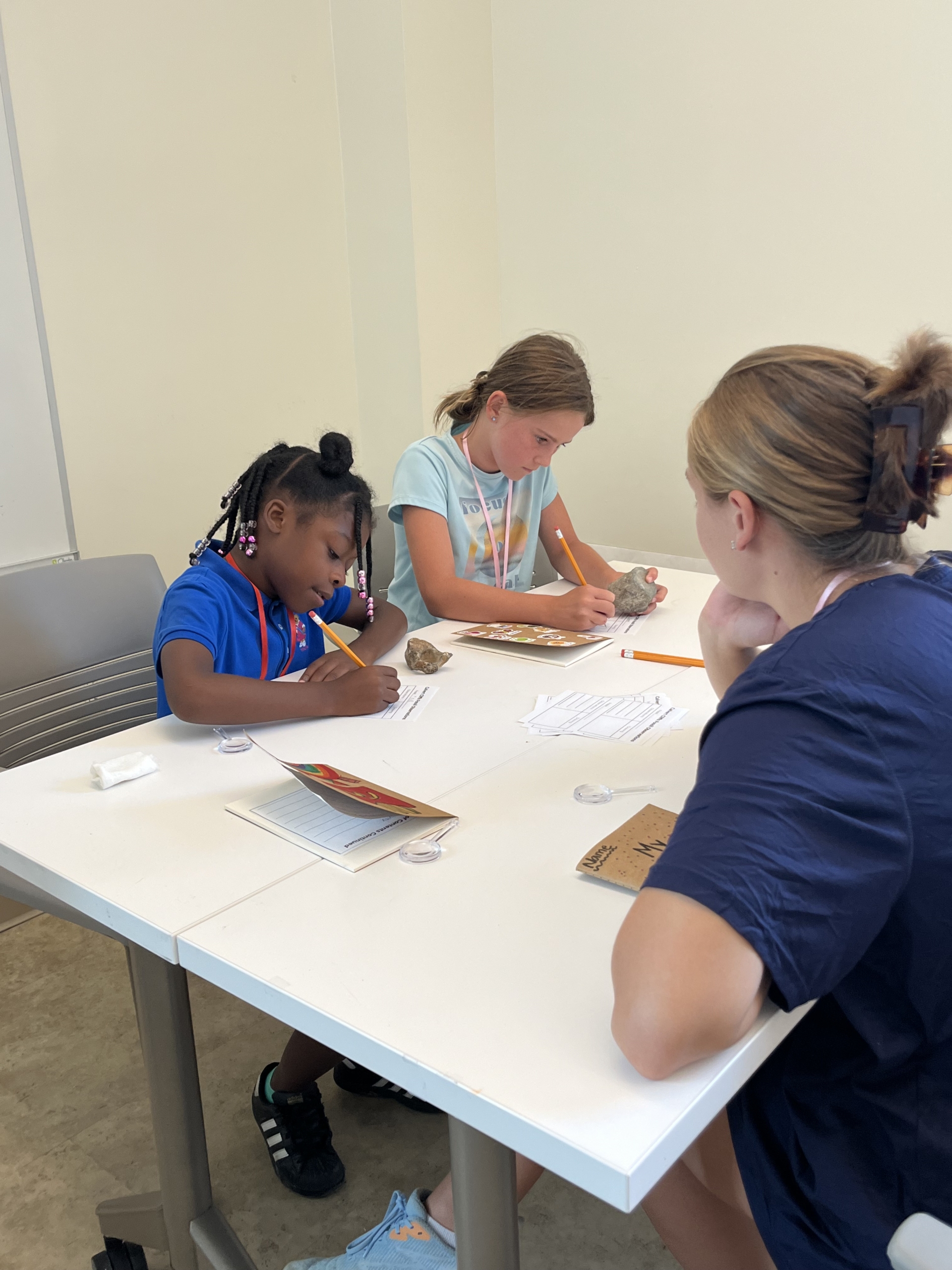 IMG_0223 Student teacher helping two young girls with their writing.