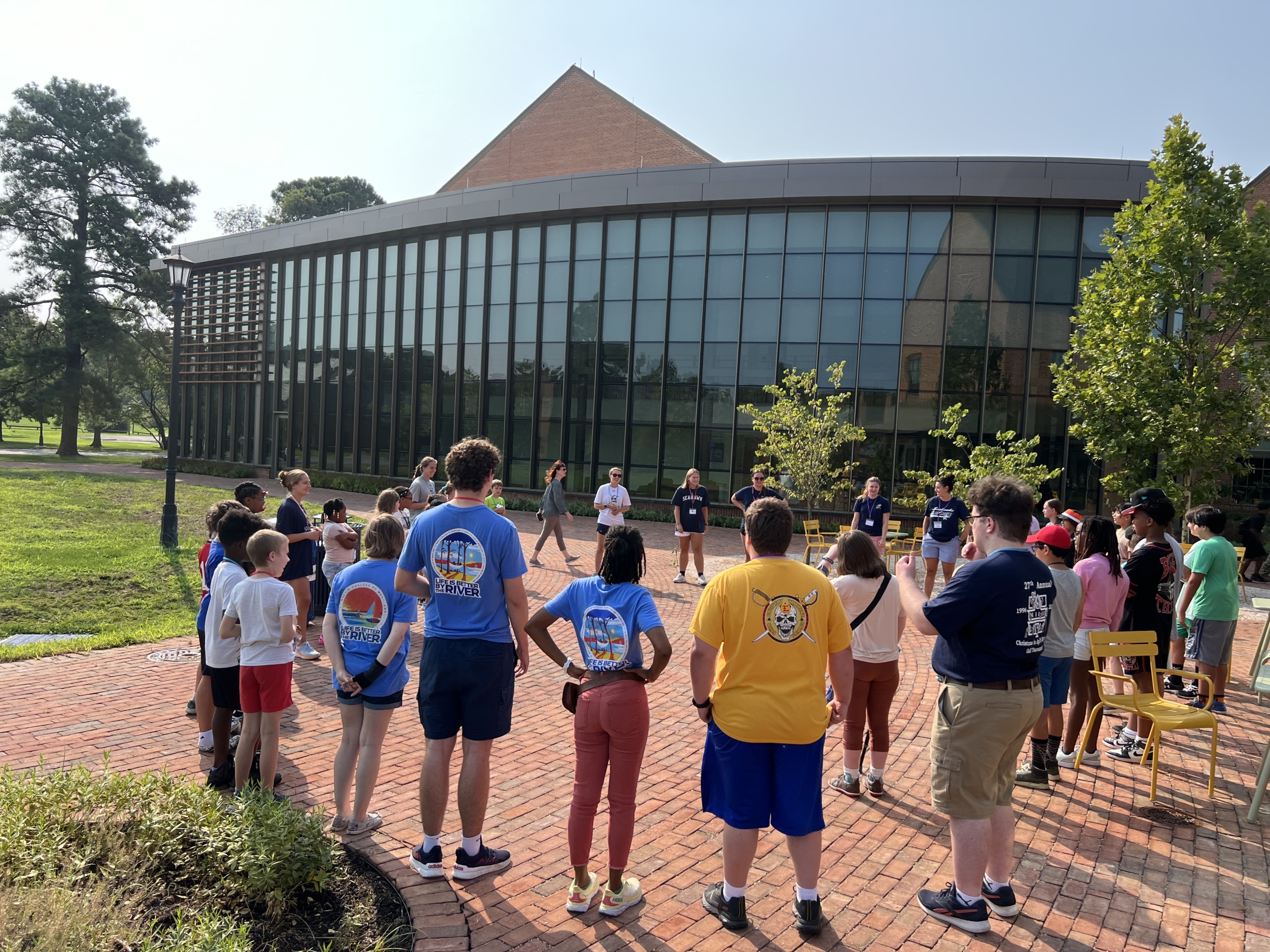 IMG_8365 Educational studies students leading a group of elementary students in a circle in front of the Learning Commons