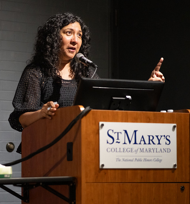 54406864987_527442897c_c A woman speaks at a podium with a microphone at St. Mary's College of Maryland, gesturing with her right hand.