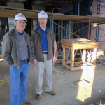 Robert Brown and Donald Wince in hard hats standing on the construction site of Anne Arundel Hall