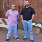 Photo of Will Looney and Josh Wilcox standing in front of the Library.