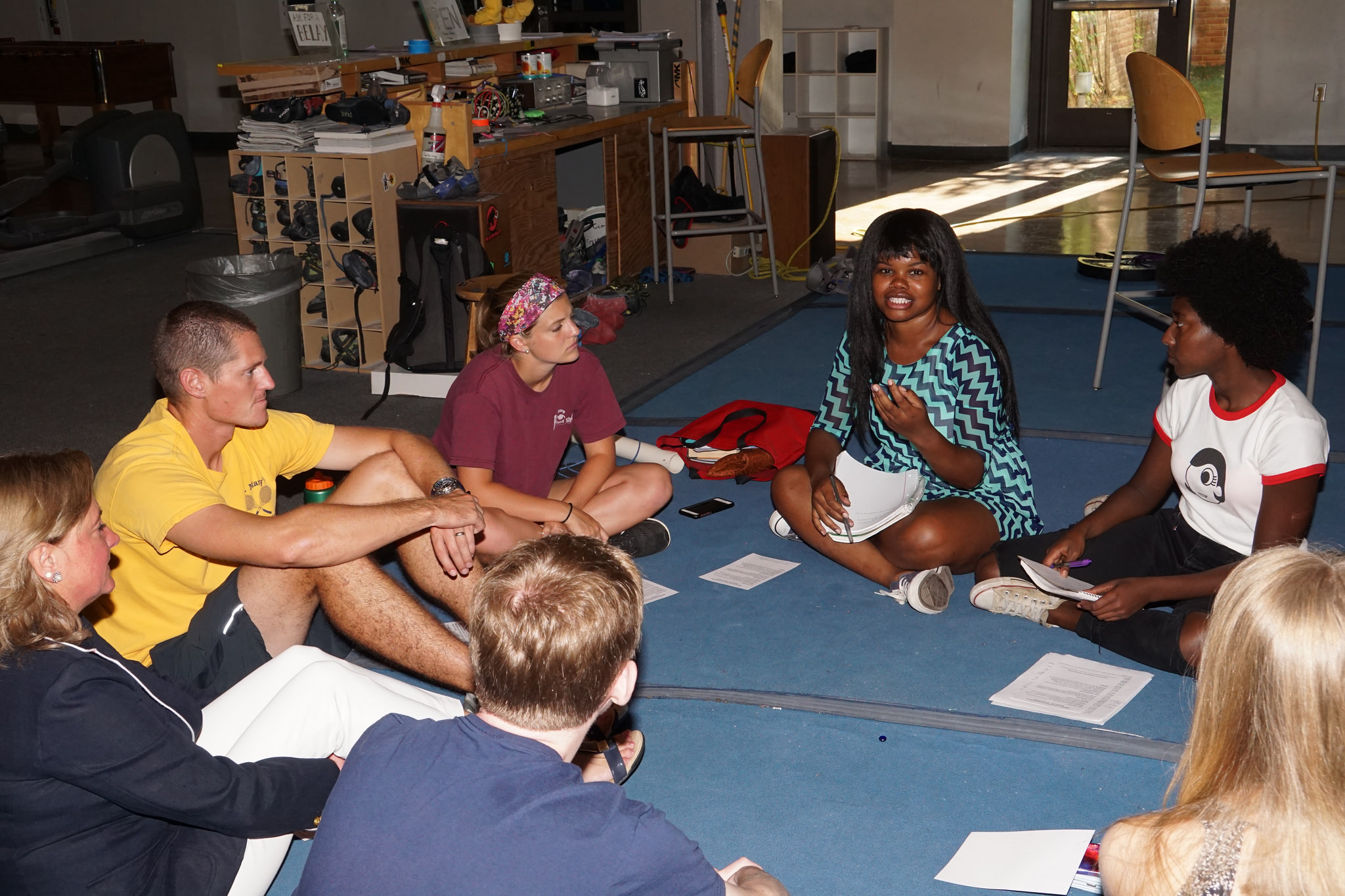 several smcm students sitting in a circle on the floor discussing sociology