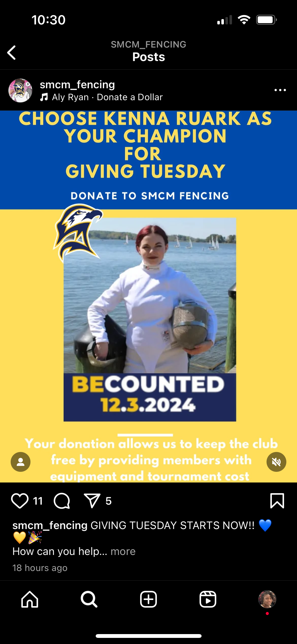 A person in fencing gear stands in front of a blue and yellow SMCM Fencing poster promoting Giving Tuesday donations, with the date 12.3.2023 highlighted.