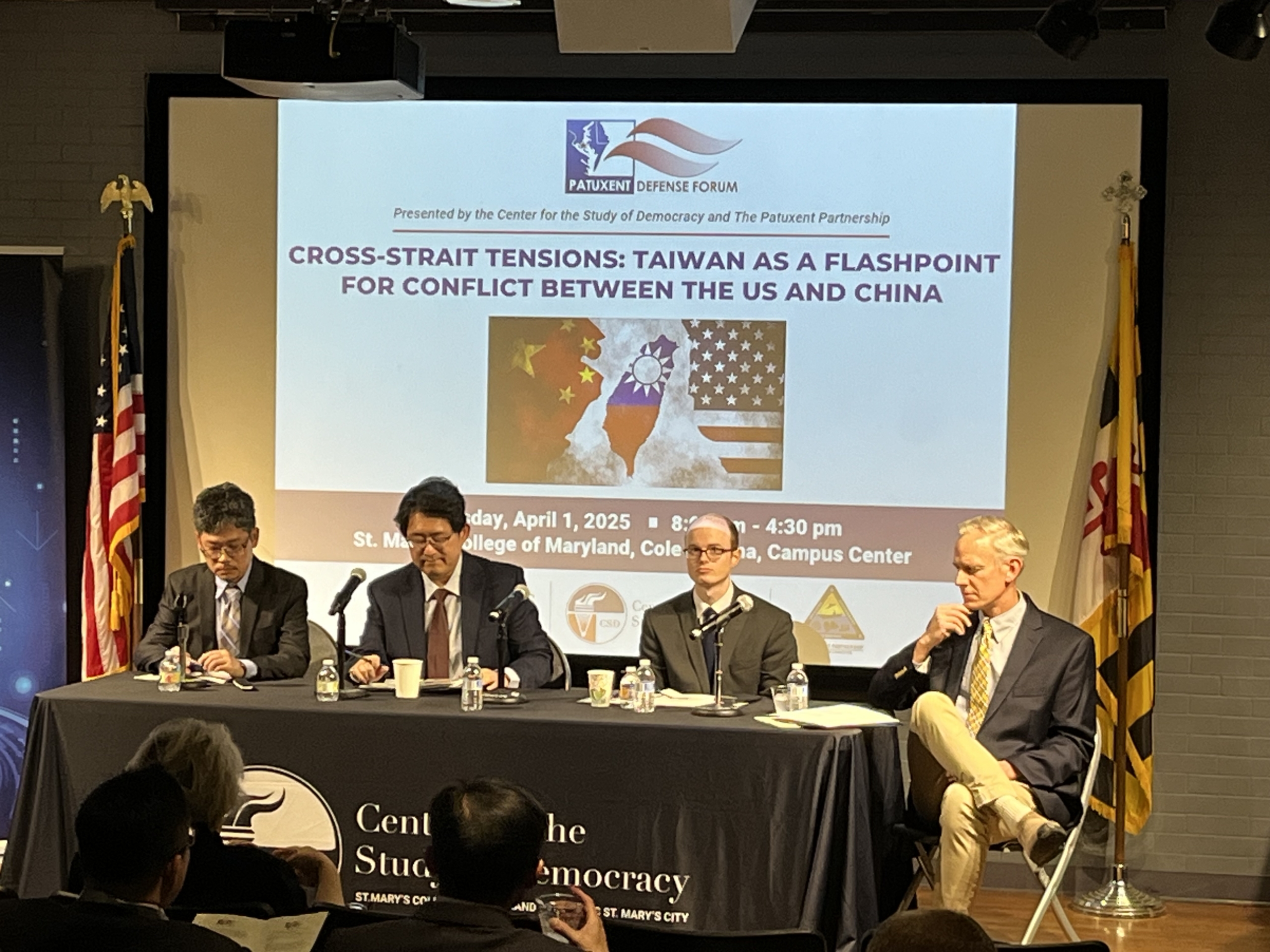  Four men sit at a panel discussion titled Cross-Strait Tensions: Taiwan as a Flashpoint for Conflict Between the US and China at St. Mary’s College of Maryland.