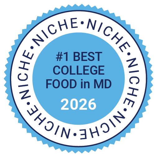 Niche_Best College Food_Light Blue A circular blue badge reads “#1 Best College Food in MD 2026” with the word “NICHE” repeated around the border.