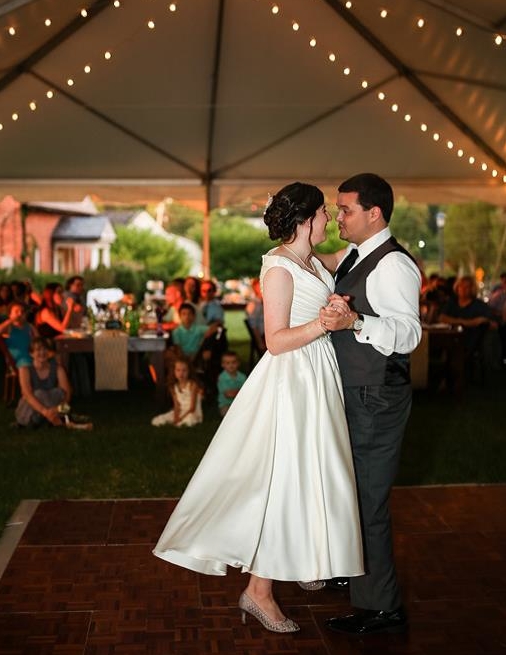 A couple dances at a tented reception after a wedding at St. Mary's College of Maryland
