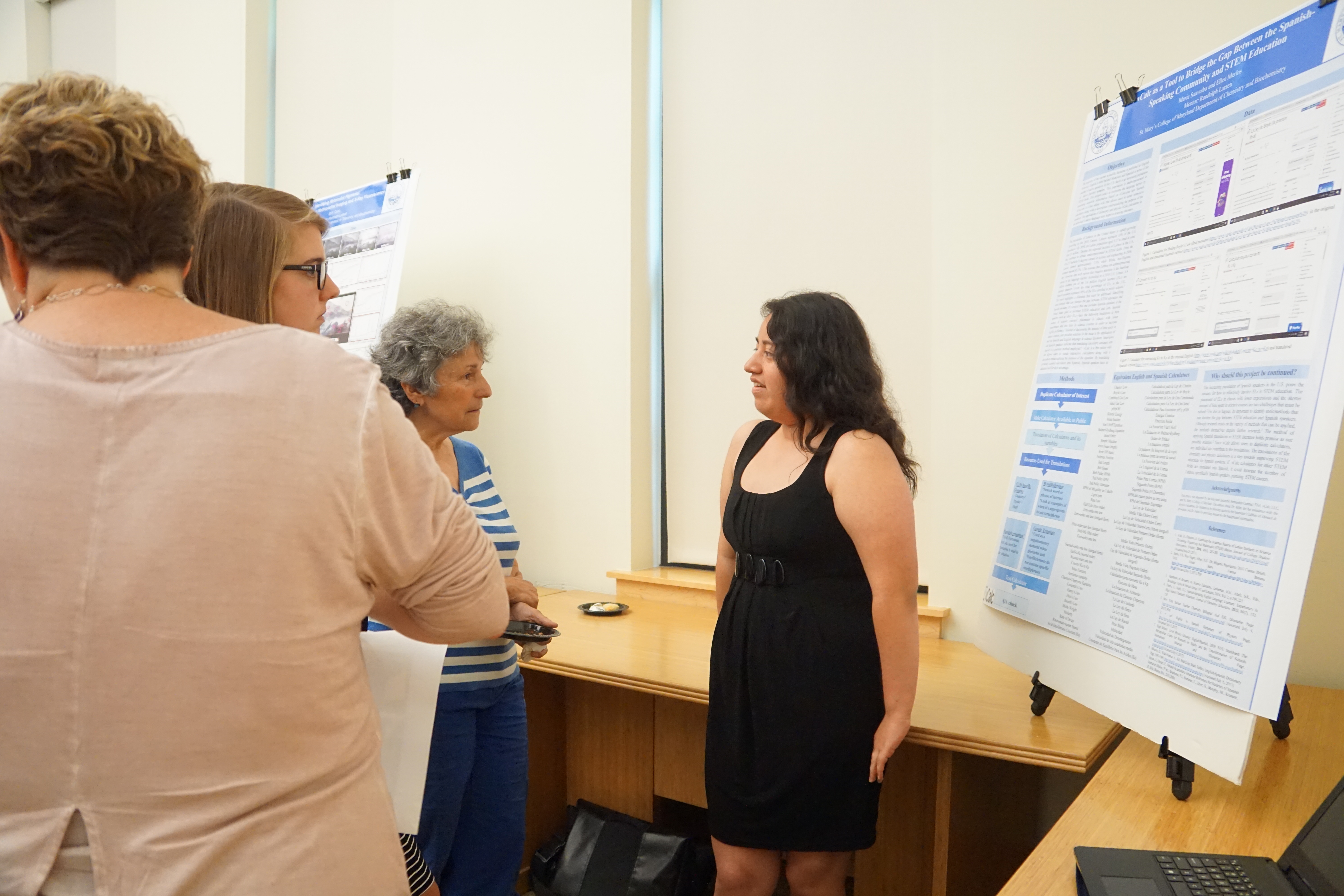 A student discussing a project with a group of several people