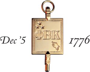 A gold key with engraved Greek letters Phi, Beta, Kappa and an image of a hand pointing up, surrounded by three stars. The dates "Dec '5" and "1776" are written in black script on either side of the key.