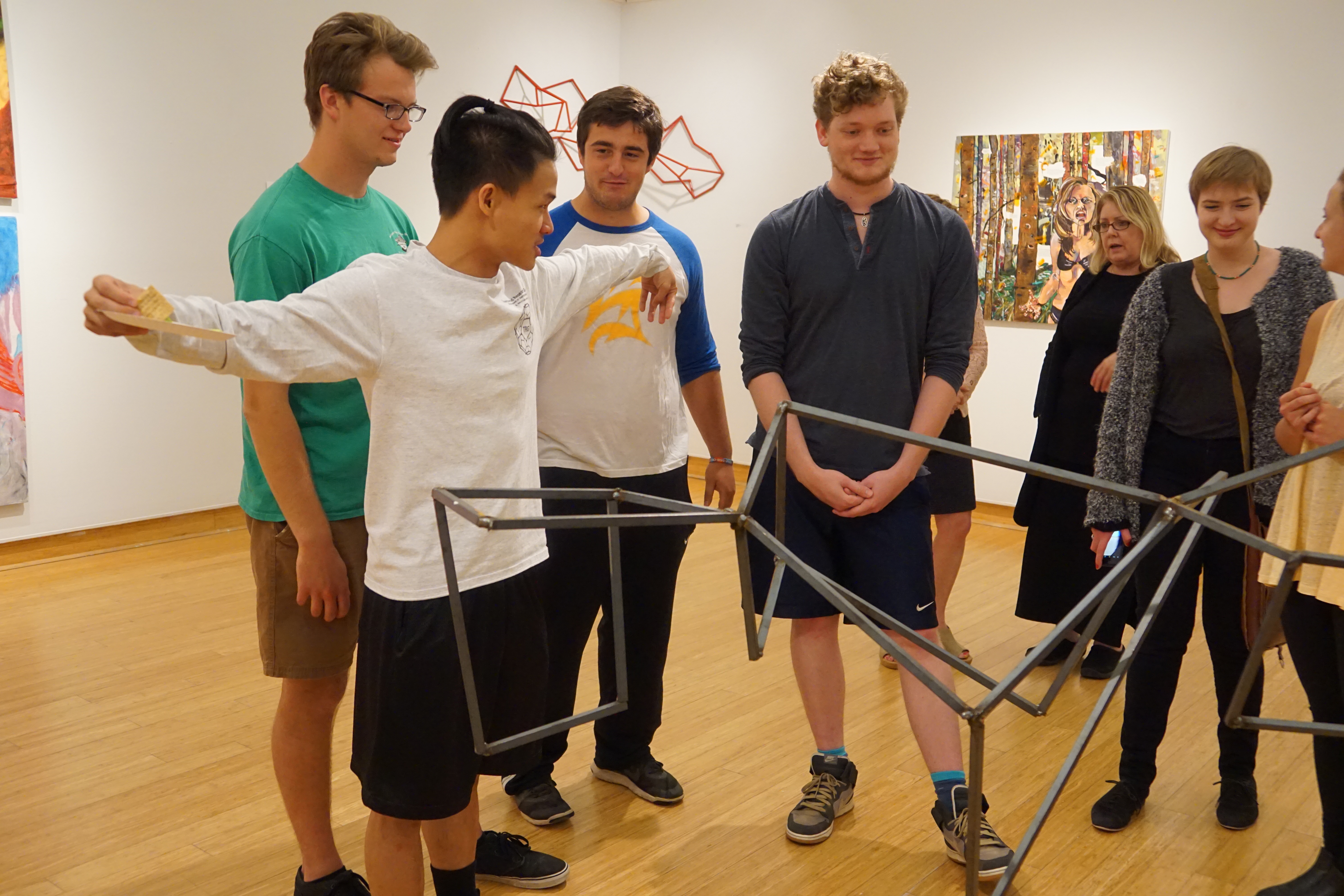 A student presenting an art piece during the 2017 Art SMP Exhibition