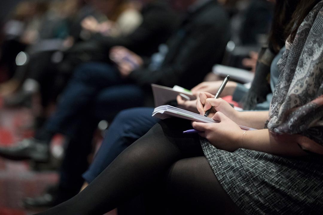 photo illustration: taking notes at a conference, workshop or presentation