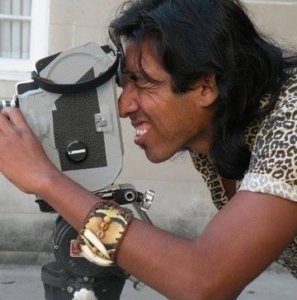 Filmmaker Alvaro Sarmiento peering through a film camera