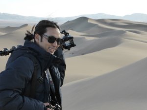 Filmmaker Stanzin Dorjai standing in a desert