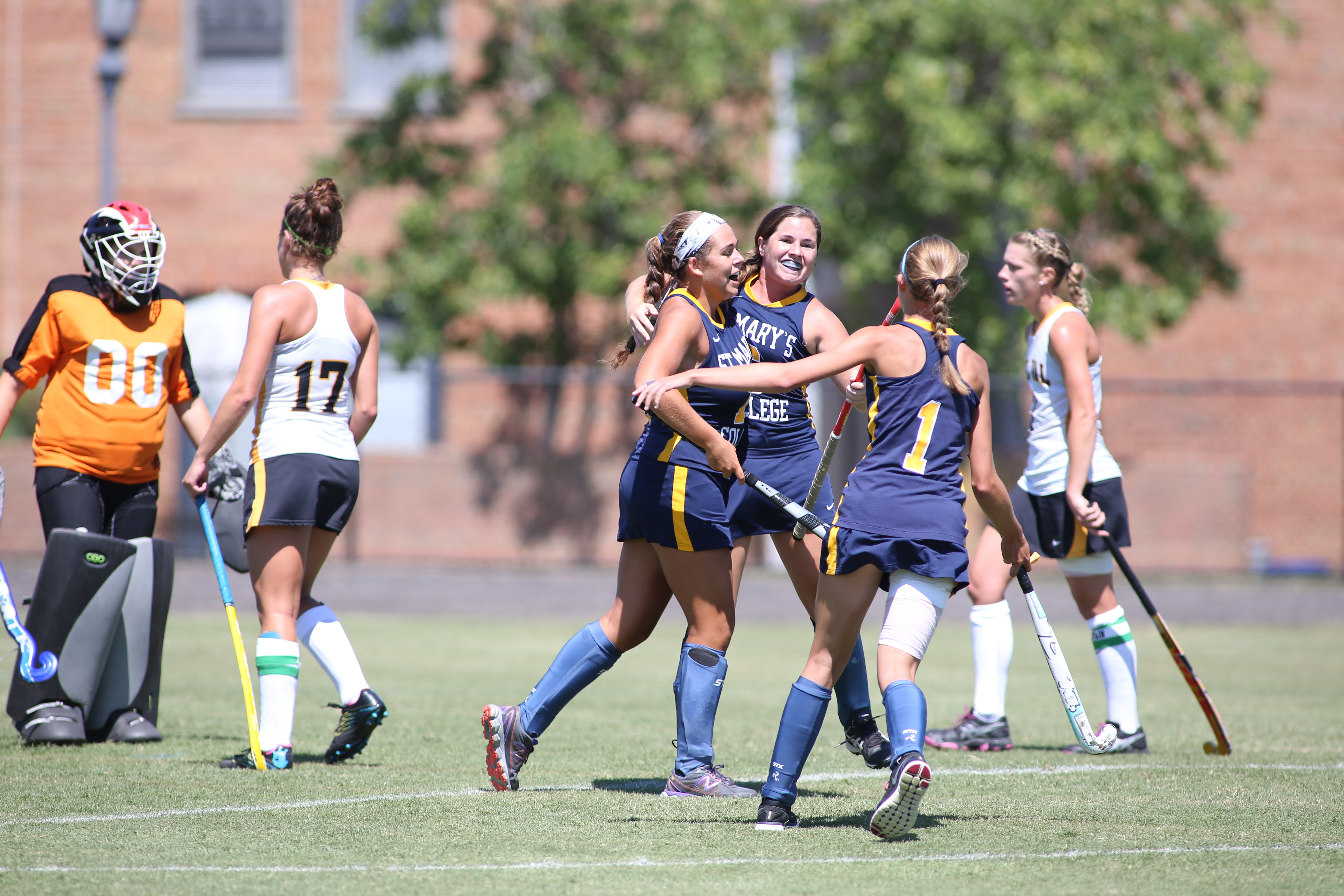 Women's Field Hockey team celebrating and hugging each other