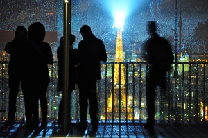Nighttime photograph of the Eiffel Tower lights in Paris, France.
