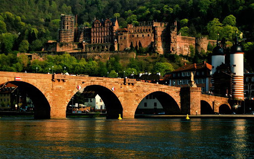 Heidelberg University, Germany - arched bridge over river with castle in background