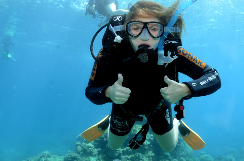 Scuba diver underwater giving thumbs up sign
