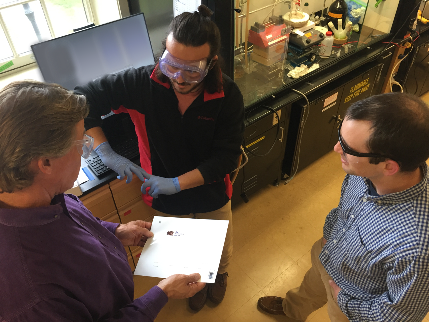 Nick D'Antona '19 explains his nanocrystal film patterns to industry partners.