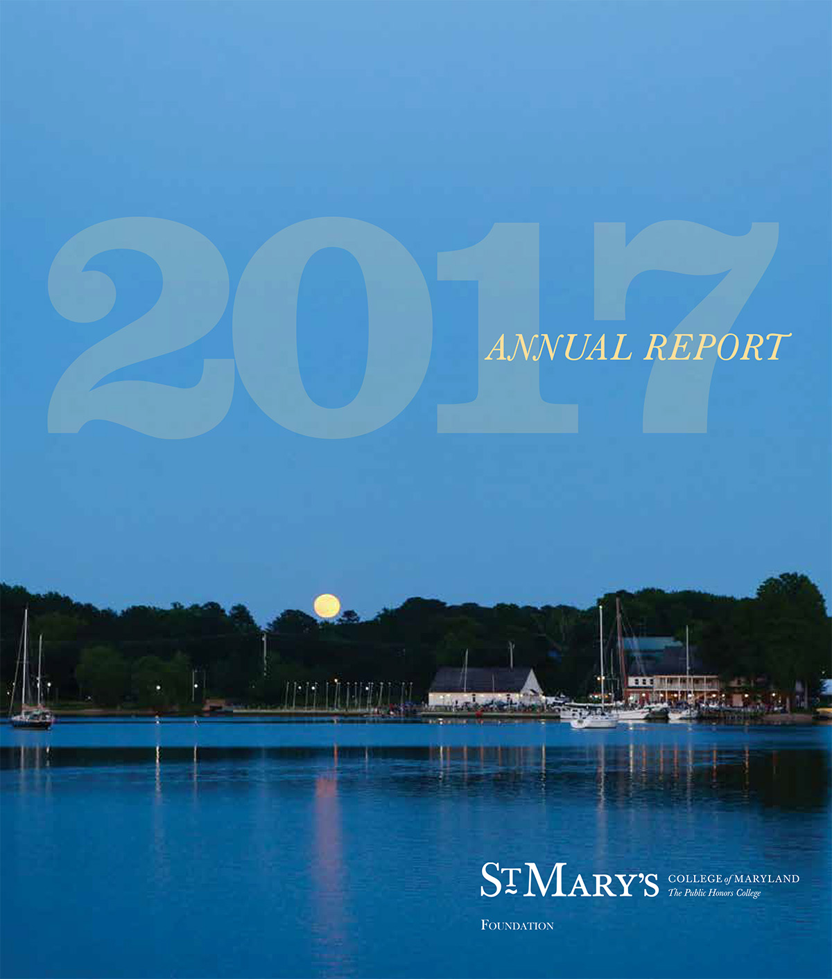 A calm evening lake scene with sailboats docked at a marina, surrounded by trees and buildings. The moon is visible on the horizon. Text reads "2017 Annual Report" and "St. Mary's College of Maryland Foundation.