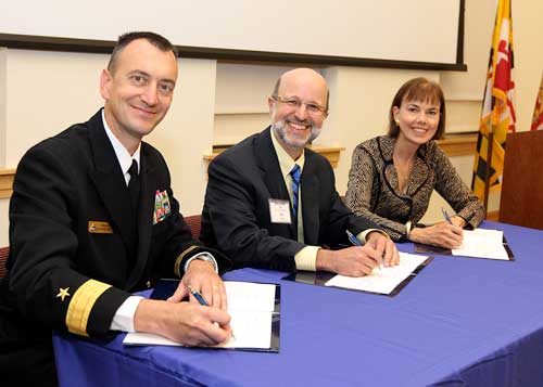 Photo by Darren Farrell: Rear Admiral Randy Mahr, Commander, Naval Air Warfare Center Aircraft Division; Joseph Urgo, St. Mary’s College president; and Bonnie Green, executive director, The Patuxent Partnership, at signing ceremony on October 18.