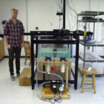 Student researcher by ultrasound tank