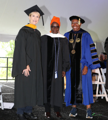 From left, Board Chair Susan Dyer, Angélique Kidjo, and President Tuajuanda C. Jordan pose on stage during Commencement