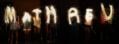 The words Math R. E. U. are spelled out with sparklers at night