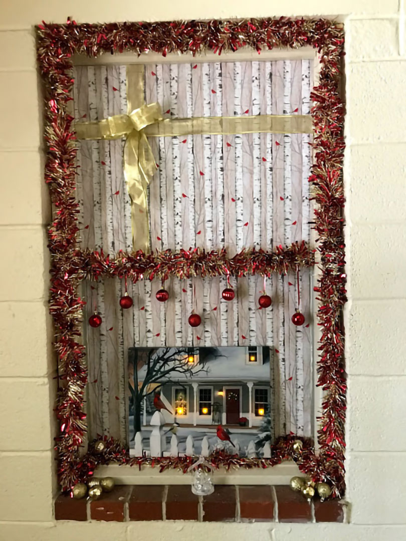 Brenda Rodgers - Holiday window display with frilled trim, ornaments, and wrapping paper bow to look like a gift wrapped package Brenda Rodgers - Holiday window display with frilled trim, ornaments, and wrapping paper bow to look like a gift wrapped package