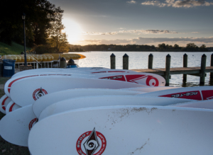 Paddle boards at the waterfront during sunset